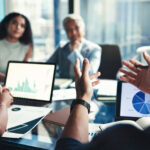 Finance, hands and tablet screen with business people in office boardroom for investment opportunity. Growth, portfolio and presentation with financial team in workplace for wealth management